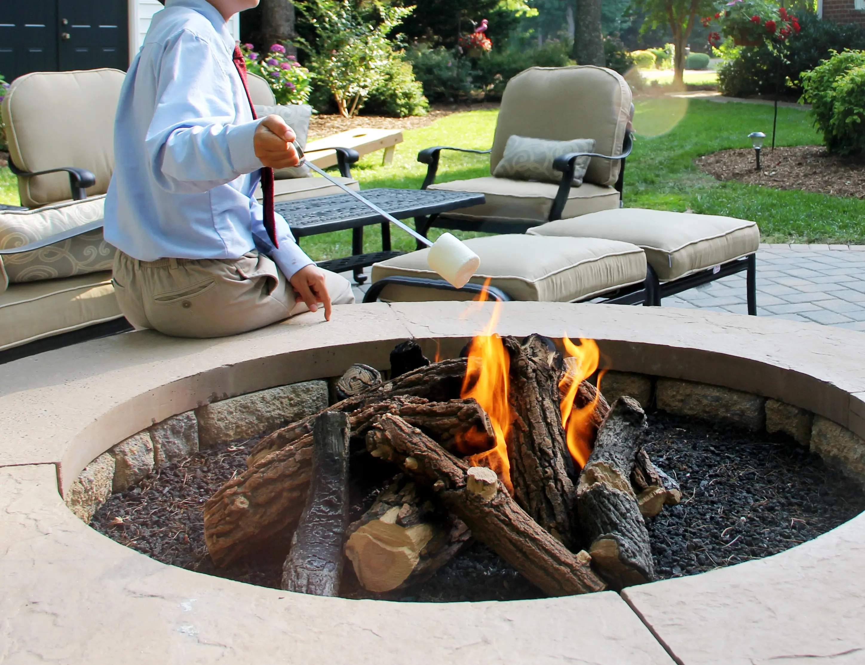 man holding marshmallow in Outdoor Fireplaces